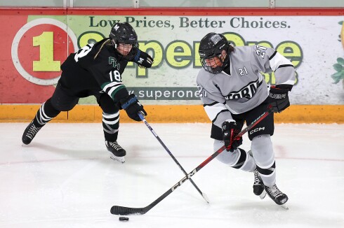 Player skates with puck.
