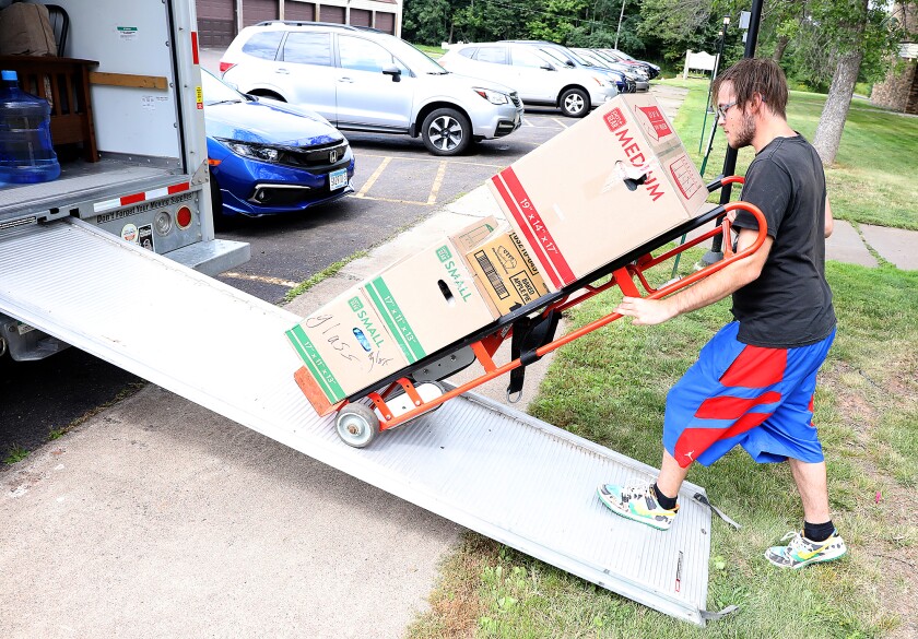 Zach Stirewalt, formerly of Cloquet,runs his dolly down the ramp as he moves his mother-in-law to an apartment in Duluth