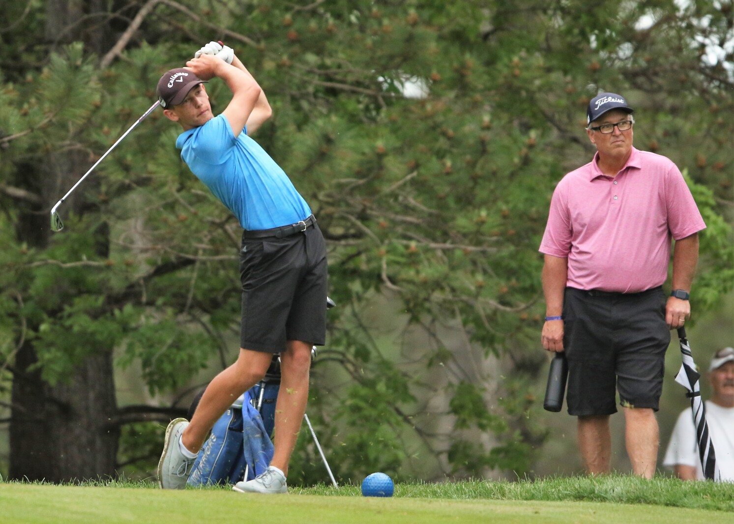 Golfer hits the ball.