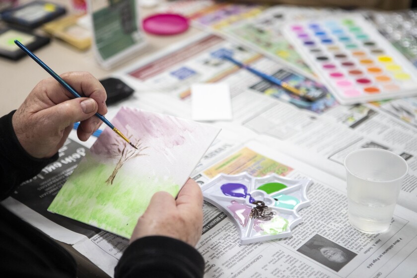 Marsha Milani works on a tree painting during the Little Art Gallery gathering at the Willmar Community Center on Tuesday, April 12, 2022.
