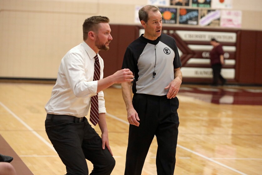 Coach talks with a ref.