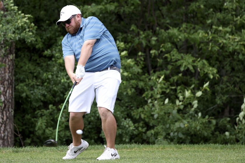 Golfer hitting a tee shot.