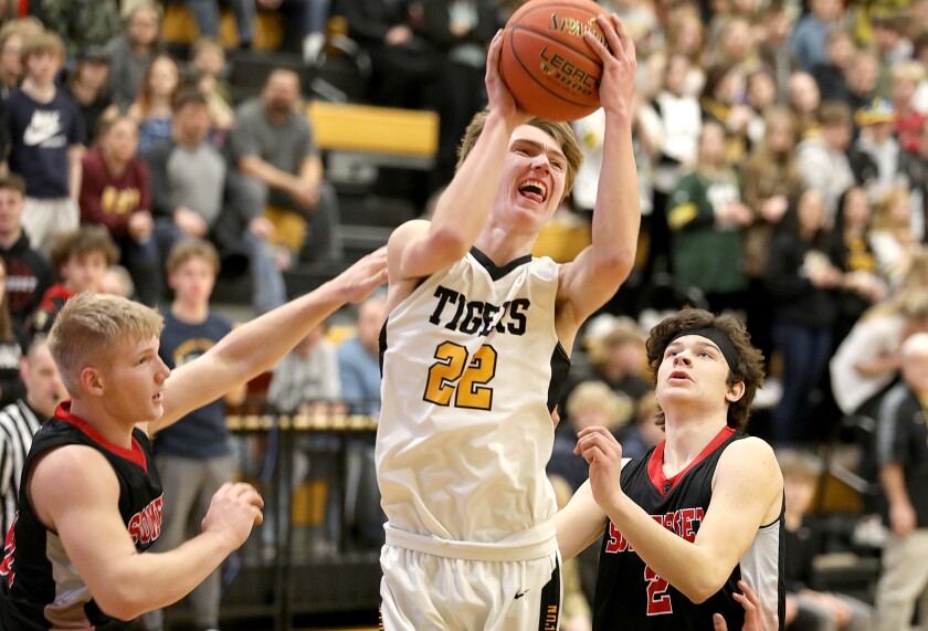 Northwestern’s Cole Lahti (22) splits the defense of Somerset’s Caymen Gebheim (51) and Dylan Leccia (2)
