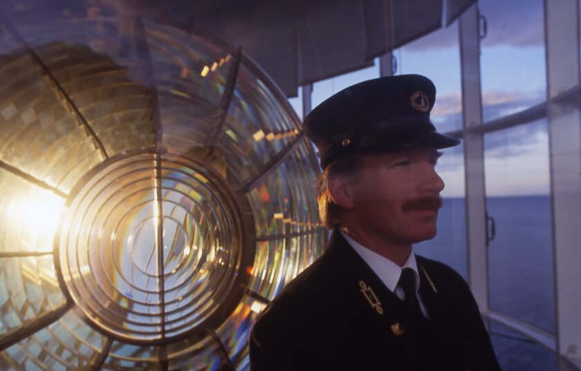 The lens of the Split Rock Lighthouse with costumed tour guide