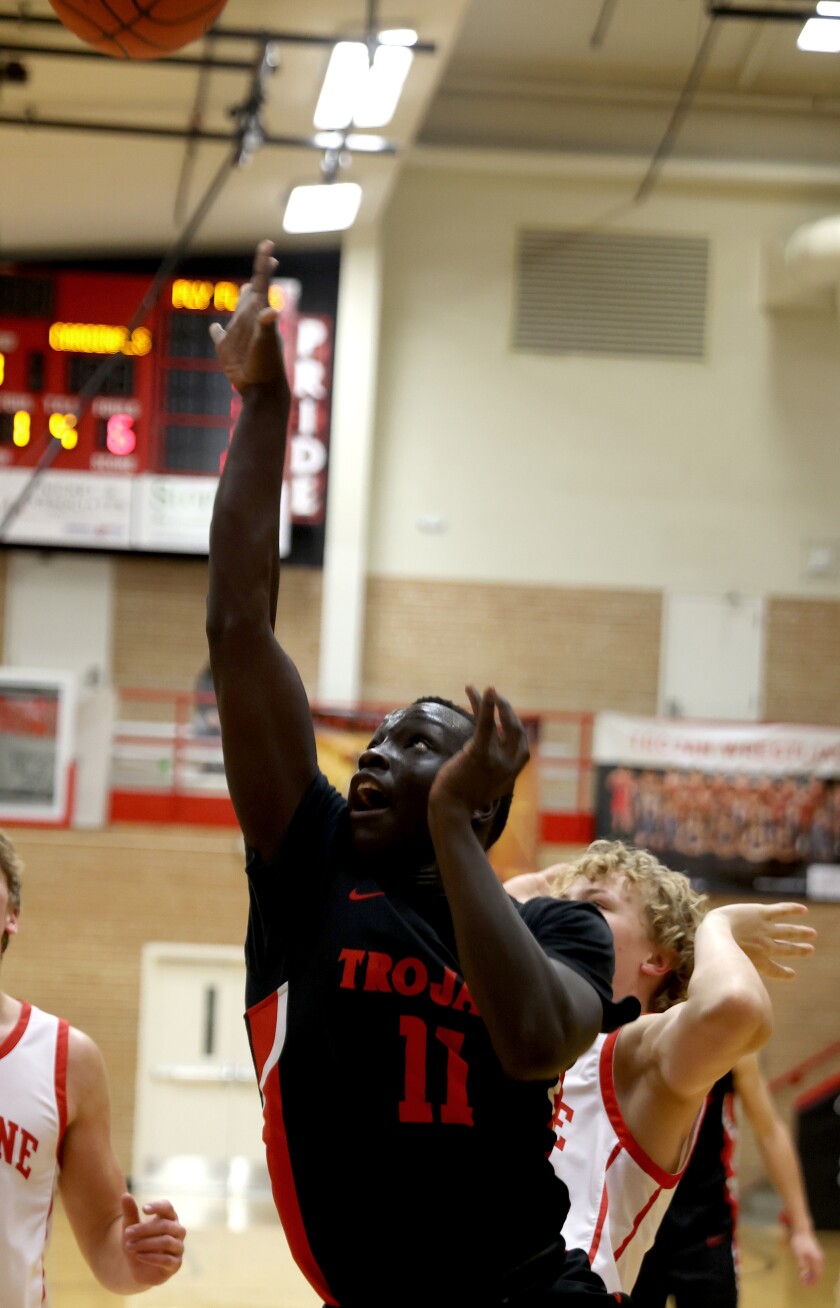 Worthington Trojans Marenono Opiew (11) fires a jump shot during a game against visiting Luverne Cardinals Thursday evening.