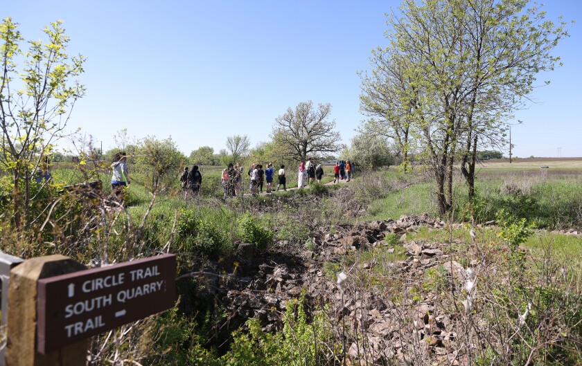 Students on a field trip walk the Circle trail at the Pipestone National Monument on May 27, 2022.