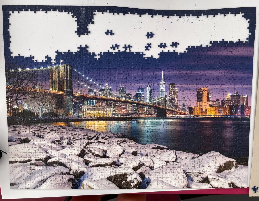 A mostly completed jigsaw puzzle featuring a cityscape.