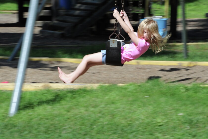 Between rain showers, Mya Kruger swings Wednesday at the U.S. Army Corps of Engineers Campground Playground in East Gull Lake. (Brainerd Dispatch/ Steve Kohls)