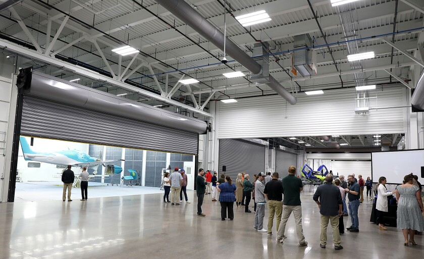 Folks mingle before the grand opening event for the Paint and Finish Facility Expansion at Cirrus Aircraft