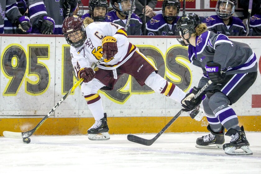 Clint Austin / caustin@duluthnews.comMinnesota Duluth's Sydney Brodt (14) shoots the puck near Minnesota State-Mankato's Claire Butorac (7) during Friday's game at Amsoil Arena.