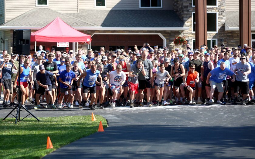 Runners take off from the starting line during a race
