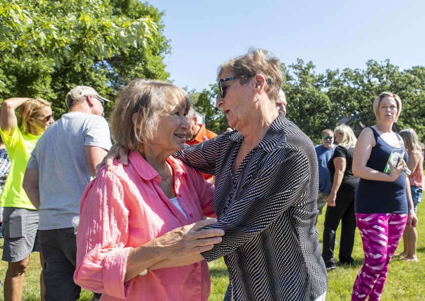 Patty Wetterling, from left, and Pam Wold share in an embrace following the memorial walk for missing Danny Newville at Old Gray Park in New London the morning of Saturday, July 30, 2022.