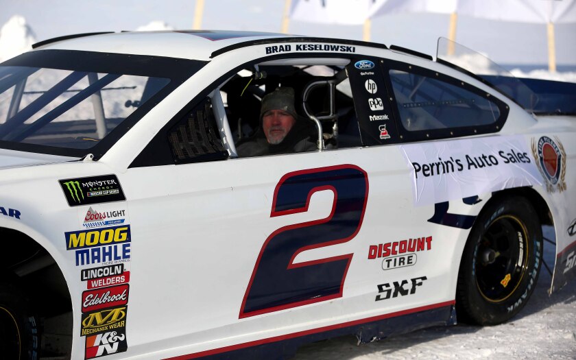 Man sitting in a retired NASCAR Cup Series car