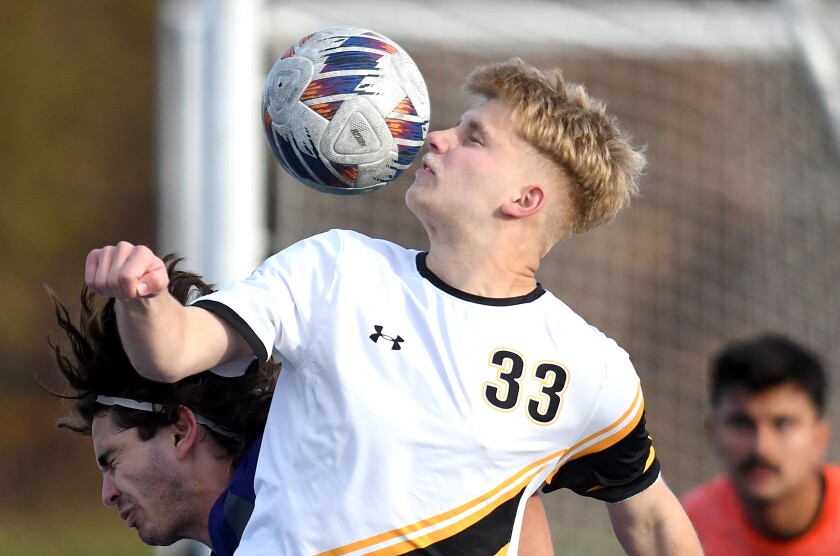 UW-Superior’s Isaac Becket (33) heads the ball towards the goal