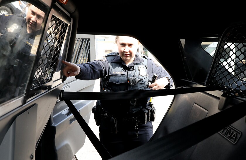 Katie Catton, who was sworn in to the Duluth Police Department in January, checks the camera in the back of her squad