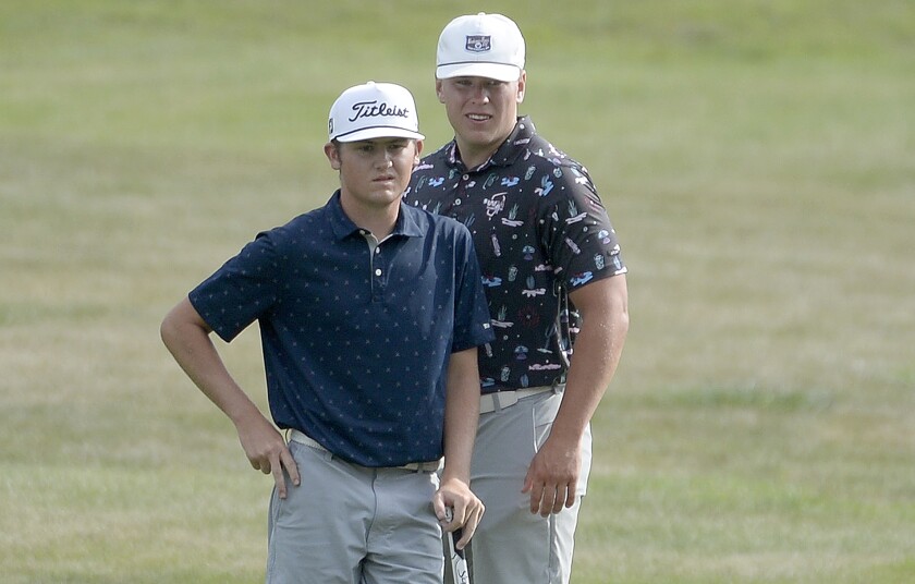 Peyton Coahran, front, and caddy Griffin Duininck look on at hole No. 2 of the Pines Course at Little Crow Golf Resort in Spicer during Day 2 of the 2022 Minnesota State Junior Boys' Championship on Tuesday, July 26, 2022.