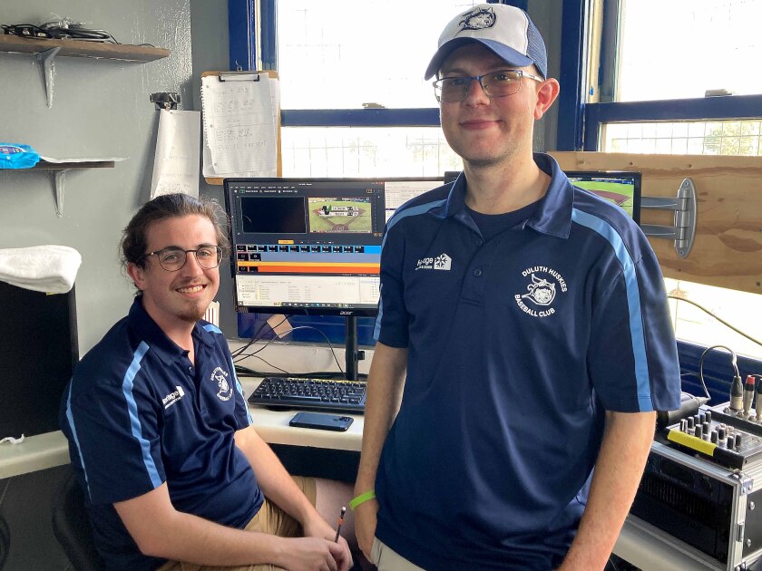 Two members of the Duluth Huskies graphics team posing
