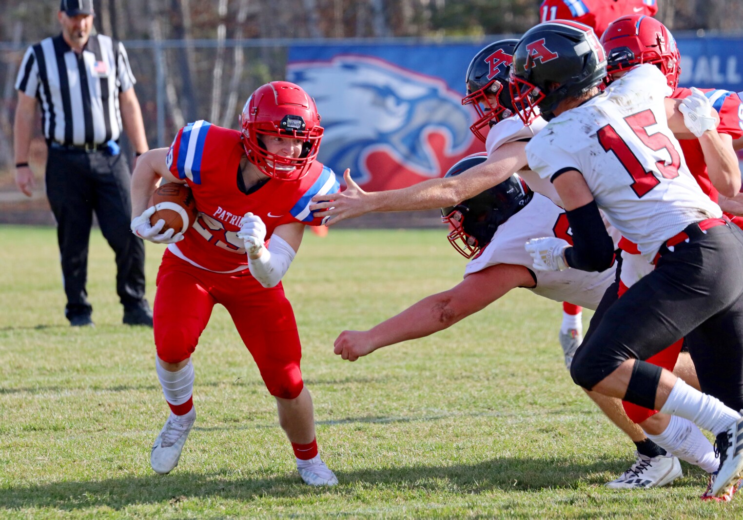 Pequot player runs with the ball. Aitkin players reach to block.