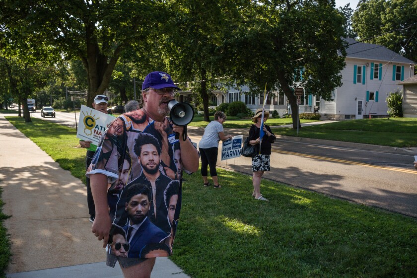 Photos Supporters for opposing school board candidates rally at the