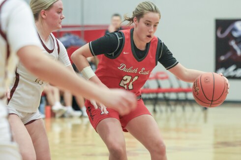 high school girls play basketball