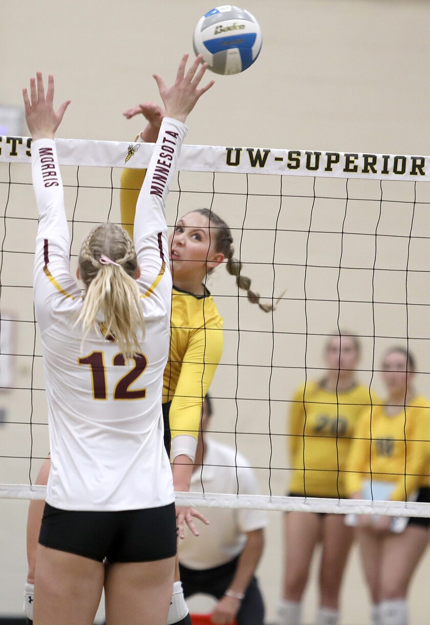 UW-Superior’s Alexie Pryd (21) hits past Minnesota Morris’ McKenzie Newton (12)