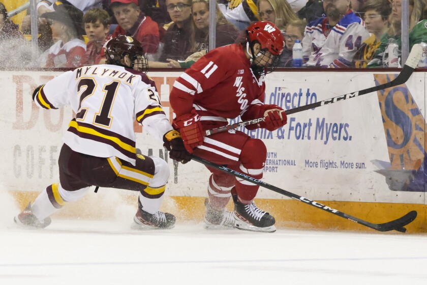 college hockey players play ice hockey