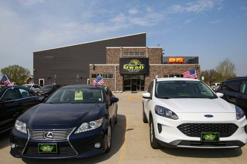 New Day Auto Sales, as seen on Friday, May 9, 2025, opened a new location at 4554 7th Ave. S. in Fargo. Some cars in the foreground and a big building in the background.