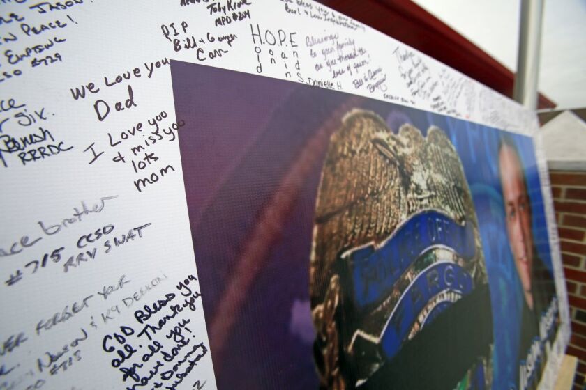 A memorial sign honoring Fargo Police Officer Jason Moszer stands in front of the Sabin Fire Department. David Samson / The Forum