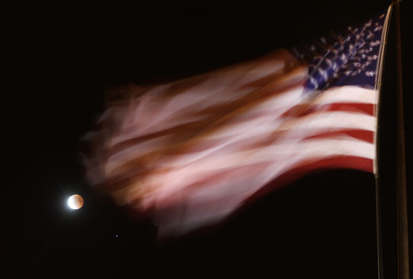Eclipse moon and Spica with flagS
