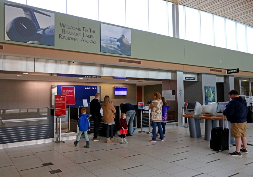 People stand in line at airport.