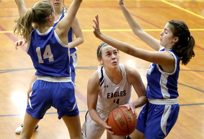 Solon Springs’ Kyra Latvala (11) splits the Mellen defense of Jordyn Delegan (14) and Rylie Yanko (12)