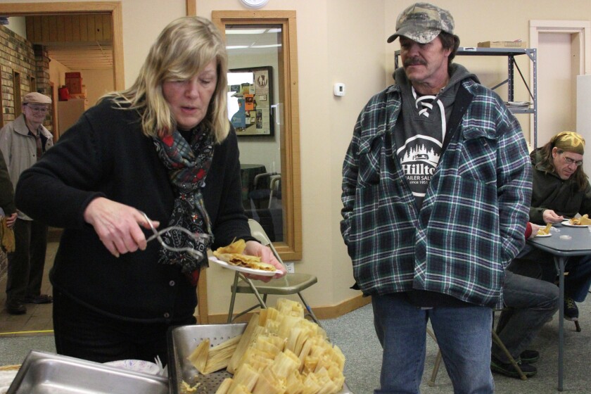 Family Center Director Leslie Bouchonville dishes up some steaming tamales for Dennis Bauman of Pine River. The Family Center and Pine River Area Food Shelf hosted an open house with tours of the new food shelf location and samples of tamales for anyone who stopped in on Feb. 15. Photo by Travis Grimler
