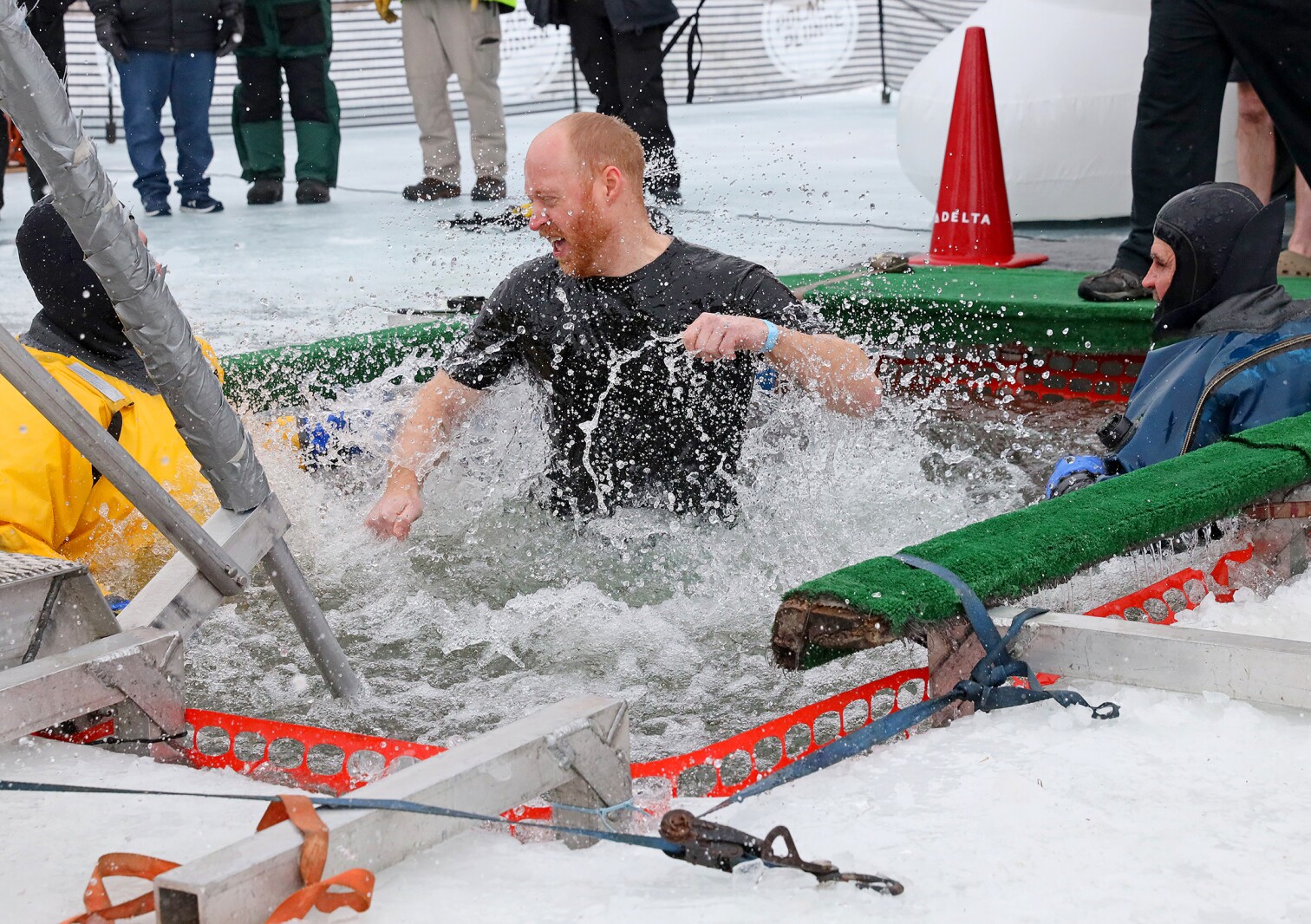 People jump into the water during the Polar Plunge event on Pelican Lake.