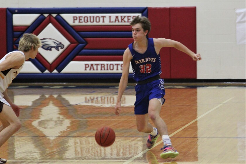 Pequot Lakes Patriot Basketball player runs past defenders
