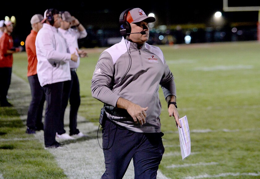 Willmar head football coach Jon Konold goes to an official to call a timeout during a North Central White District game against Delano on Friday, Sept. 30, 2022 at Hodapp Field.