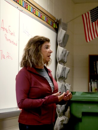 Worthington Middle school teacher Paula Stock discusses with her students how different writers have changed the tone of the ending of a movie about Anne Frank on Friday, May 20, 2022.