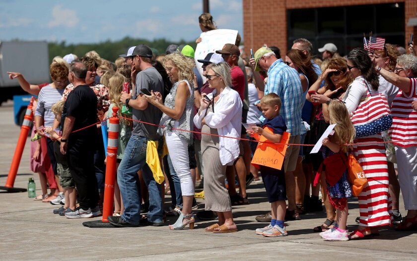 People gather to wait for service members
