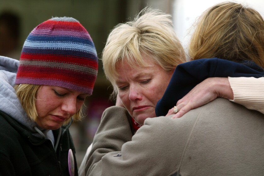 Dru Sjodin's mother, Linda Walker, embraces her daughter's sorority sisters, Elizabeth Hensler and Lauren Teetzen after they learned that Dru's body had been found April 17, 2003, near Crookston. PHOTO BY JACKIE LORENTZ/GRAND FORKS HERALD