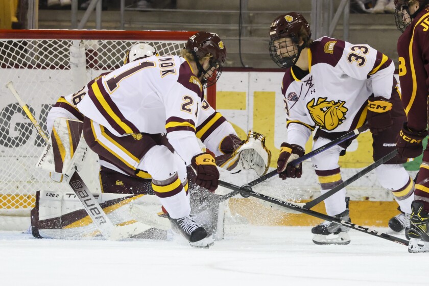 College hockey players play game in indoor arena