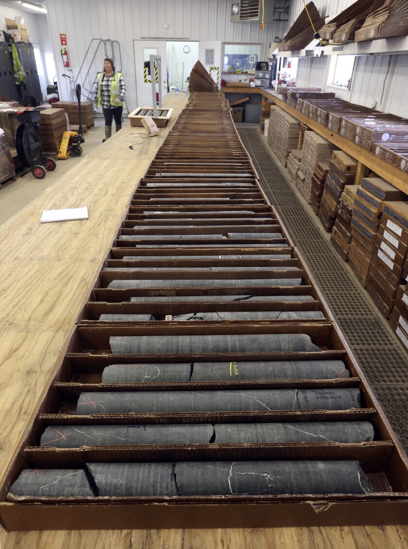 Core samples in boxes lay across a table.