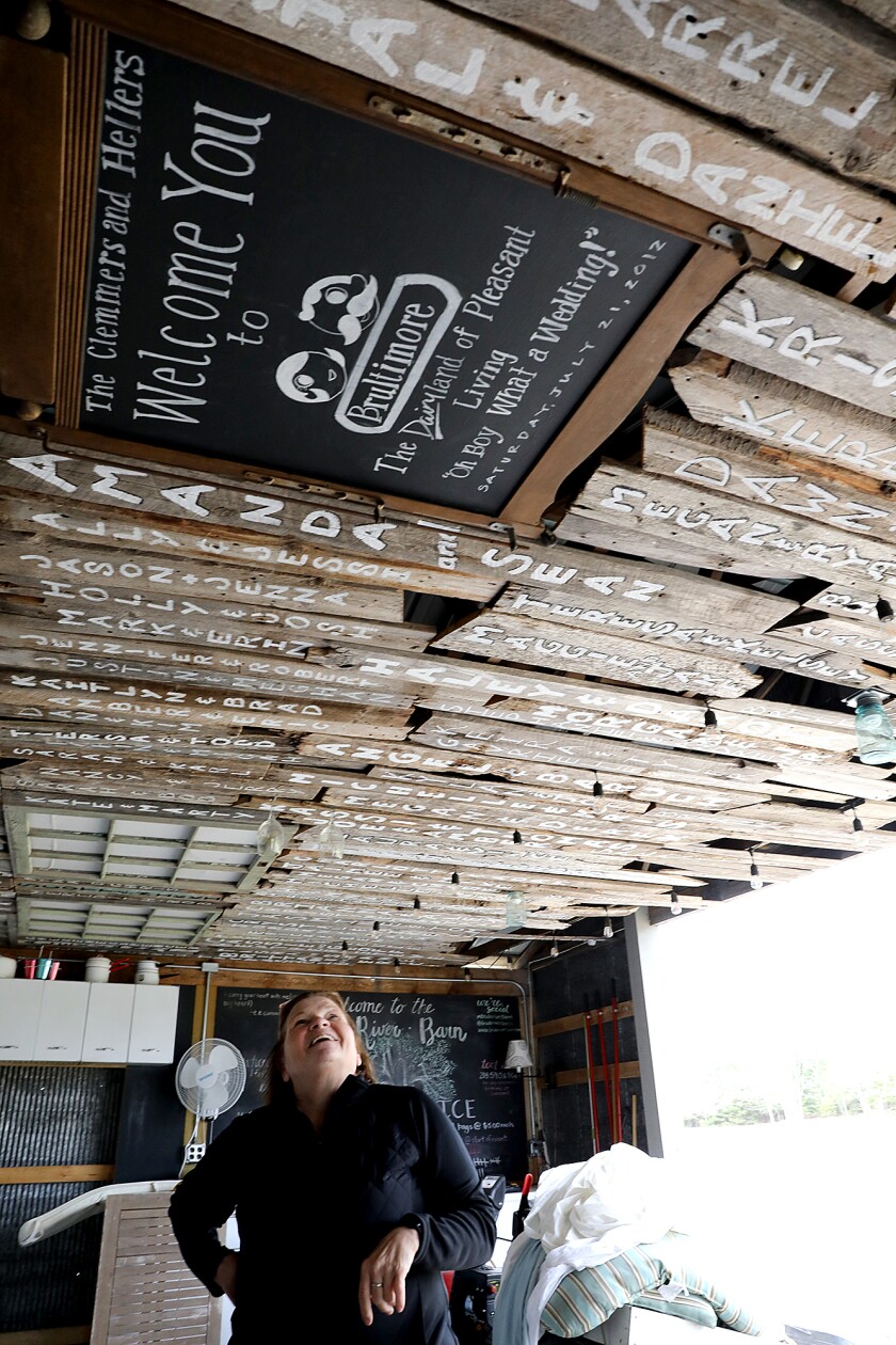 Jill Clemmer looks up at names of couples that have been married at the Brule River Barn
