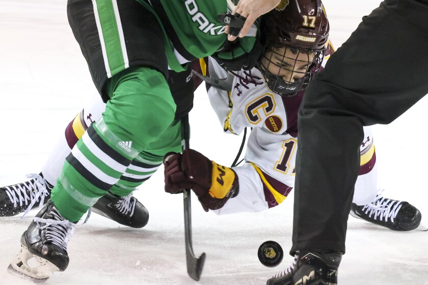 college men play ice hockey