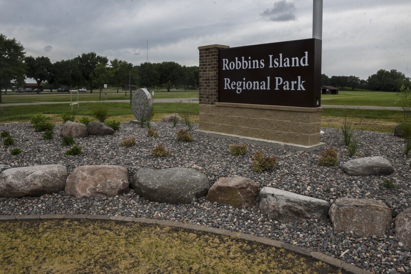 The new sign at Robbins Island Regional Park in Willmar features block letters, a flag pole and a plant bed with a rock border.