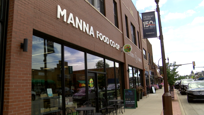 A brick building with the words "Manna Food Co-op" in white.