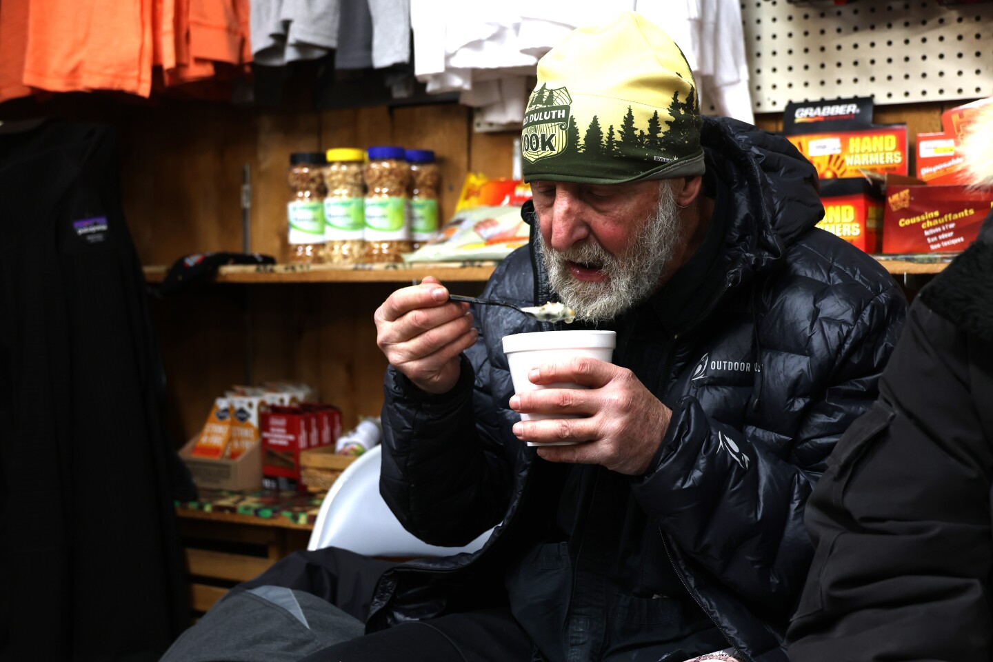Arrowhead 135 runner rests and eats a cup of soup