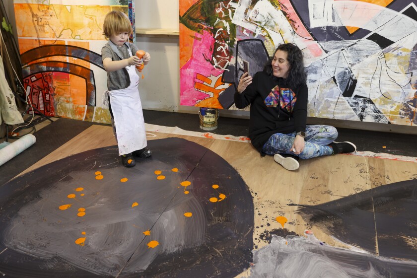 A family creates abstract paintings together in a home studio