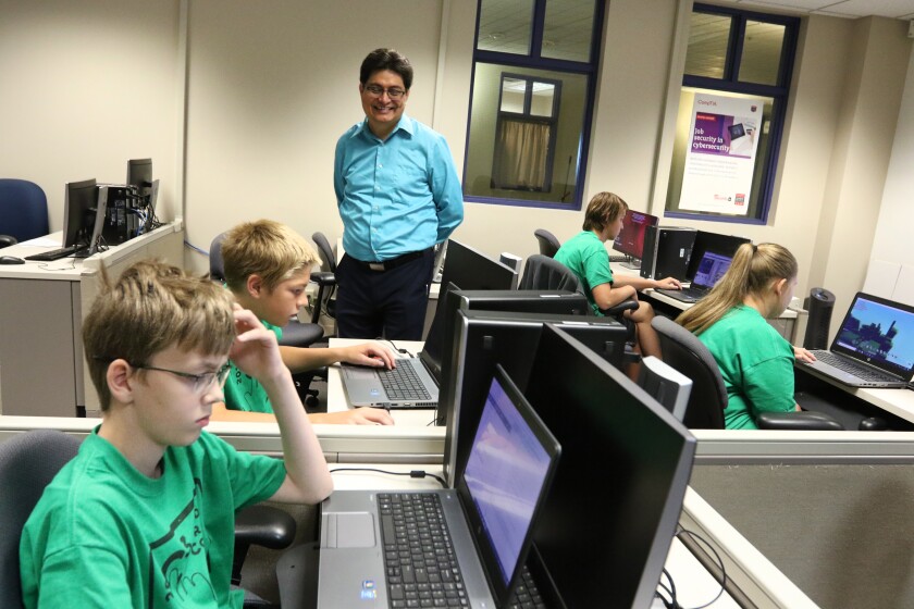 Instructor Sam Espana walks through the classroom as students work on their projects during Coding Camp Thursday, Aug. 2, at Central Lakes College in Brainerd. Kelly Humphrey / Brainerd Dispatch - Video