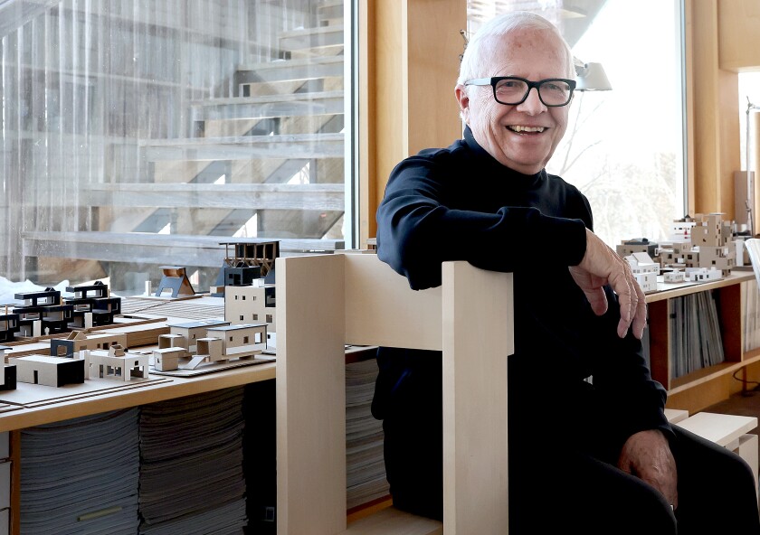 Architect smiles on bench.