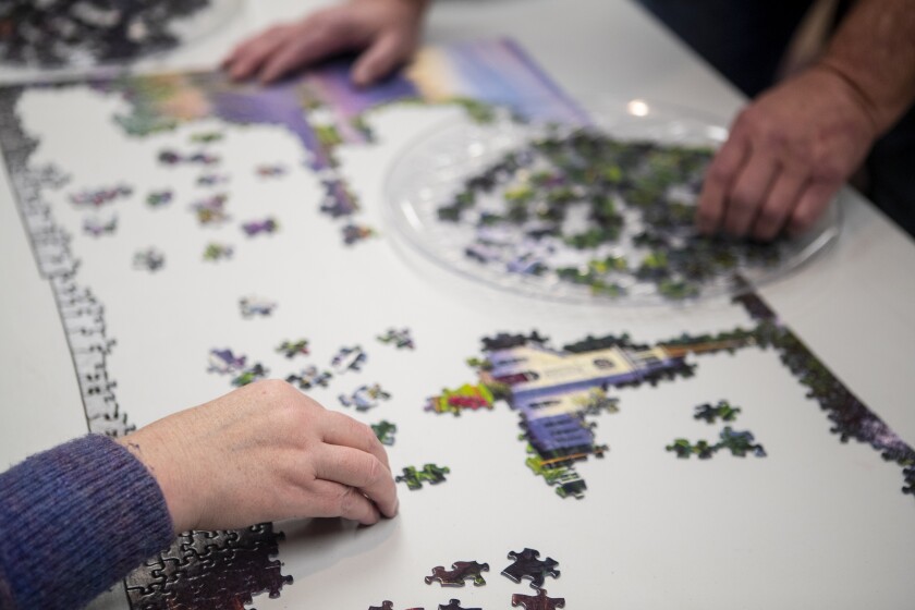 As a passion for both of them, Kelly, left, and Bob Rodenberg, spend time working together on a large-scale puzzle at the GlenOaks Senior Living Campus in New London on Tuesday, March 29, 2022.