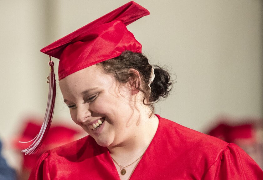 Senior guest speaker Grace Lynum smiles while walking across the stage during the Area Learning Center's senior graduation ceremony on Thursday, May 19, 2022.
